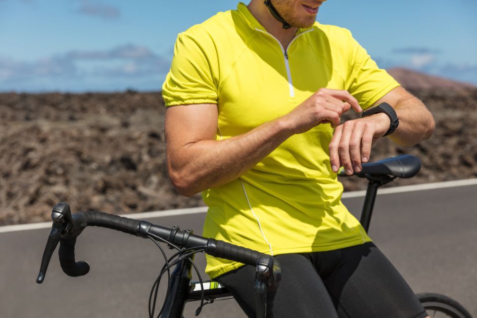 Cyklista si sleduje vzdialenosť na svojom smart náramku.